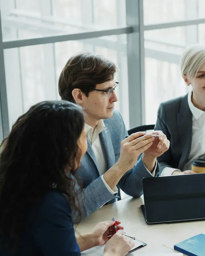 A small leadership team working through a discussion at a shared table